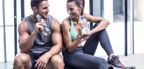 Muscular,Couple,Discussing,On,The,Bench,And,Holding,Water,Bottle